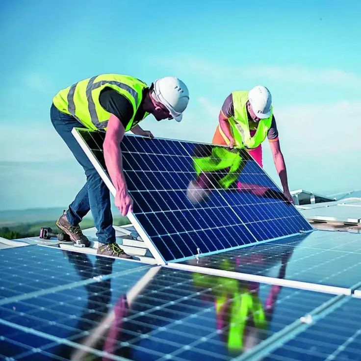 Equipe técnica instalando painéis solares em telhado residencial.